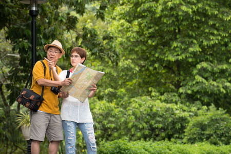 Image of happy romantic Asian senior couple outdoor in park