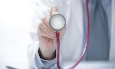 Medical doctor holding stethoscope in hospital setting