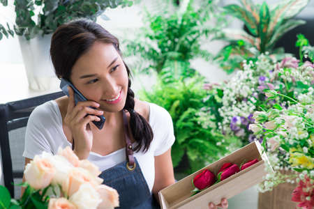 Young Asian woman entrepreneur/shop owner/ florist of a small flower shop business