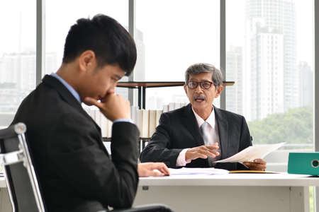 Angry boss yelling at employee, business concept, Asian businessmanの写真素材