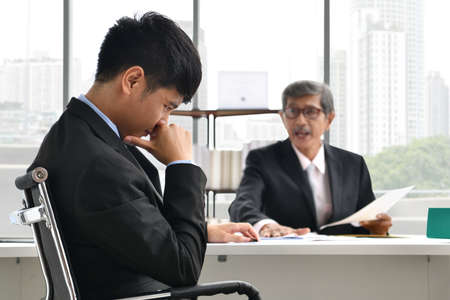 Angry boss yelling at employee, business concept, Asian businessmanの写真素材