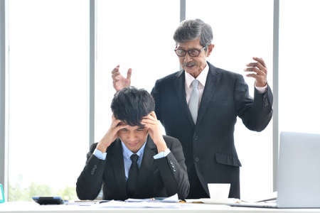 Angry boss yelling at employee, business concept, Asian businessmanの写真素材