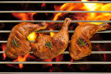 Top view of grill bbq roast chicken thigh on the flaming grillの写真素材