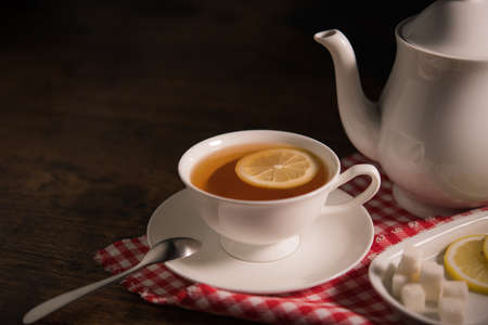 Cup of tea with lemon on wooden tableの写真素材