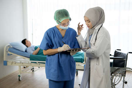 Asian female doctors team discussing patient's case in the room at the hospitalの写真素材