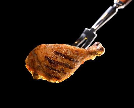 Grill roast bbq chicken leg isolated on black backgroundの写真素材