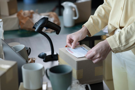 Female online store small business owner entrepreneur packing package post shipping box preparing...