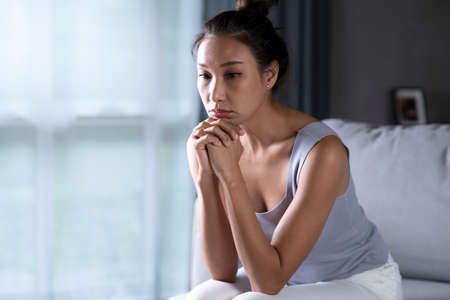 Asian woman feeling sad tired and worried suffering depression in mental health, Unhappy female...