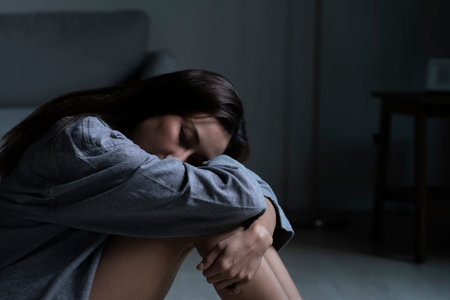 Young Asian woman in bedroom feeling sad tired and worried suffering depression in mental healthの写真素材