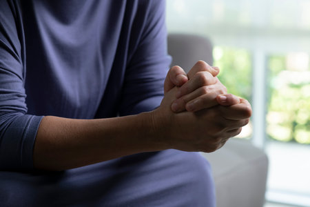 Female hands showing stress, senior woman feeling sad tired and worried suffering depression in mental healthの写真素材