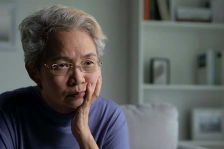 Portrait of sad and lonely Asian senior woman in living roomの写真素材
