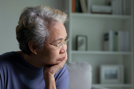 Portrait of sad and lonely Asian senior woman in living roomの写真素材