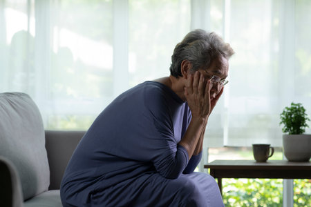 Portrait of sad and lonely Asian senior woman in living roomの写真素材