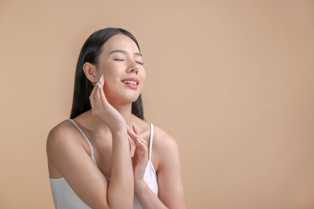 Portrait of a young Asian woman with natural makeup and natural styling. Advertising natural cosmetics. Advertising for a beauty salon. Care cosmetics, face and body skin care.の写真素材