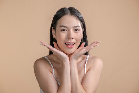 Portrait of a young Asian woman with natural makeup and natural styling. Advertising natural cosmetics. Advertising for a beauty salon. Care cosmetics, face and body skin care.の写真素材