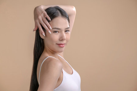 Portrait of a young Asian woman with natural makeup and natural styling. Advertising natural cosmetics. Advertising for a beauty salon. Care cosmetics, face and body skin care.の写真素材