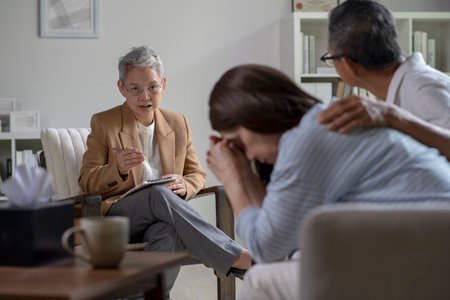 Mature Asian couple consulting couple relationship counselling to solve problemsの写真素材