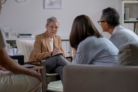Therapist, psychologist talking and counselling to people in group therapy.の写真素材