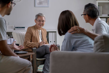 Therapist, psychologist talking and counselling to people in group therapy.の写真素材