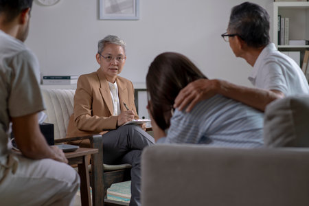 Therapist, psychologist talking and counselling to people in group therapy.の写真素材