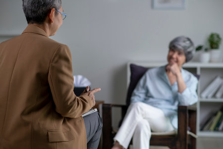 Therapist, psychologist talking and counselling to Asian patient at office during psychology treatment.の写真素材