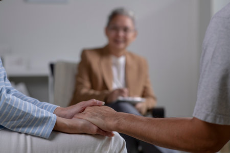 Asian couple consulting couple relationship counselling to solve problems. Asian psychiatrist talking to young couple in officeの写真素材