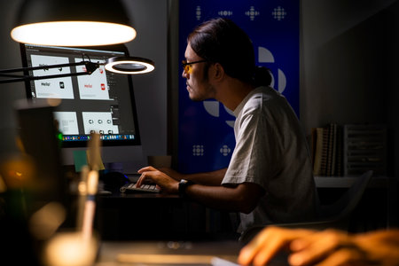 Asian man graphic designer working on computer drawing sketches logo design. The concept of a new brand. Professional creative occupation with idea.の写真素材
