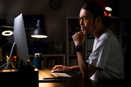 Asian man graphic designer working on computer drawing sketches logo design. The concept of a new brand. Professional creative occupation with idea.の写真素材
