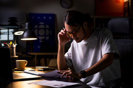 Asian man graphic designer working on computer drawing sketches logo design. The concept of a new brand. Professional creative occupation with idea.の写真素材