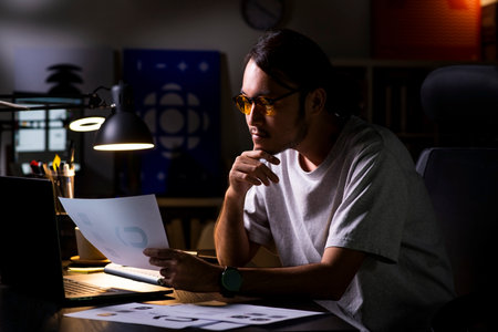 Asian man graphic designer working on computer drawing sketches logo design. The concept of a new brand. Professional creative occupation with idea.の写真素材