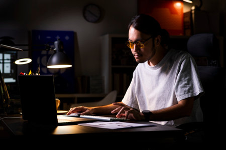 Asian man graphic designer working on computer drawing sketches logo design. The concept of a new...