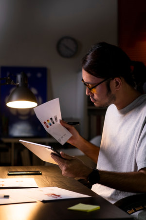 Asian man graphic designer working on computer drawing sketches logo design. The concept of a new...