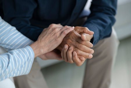 Senior couple holding hands for love, care and trust in home, connection and motivation for mental health.People, comfort and partner for help with kindness, bonding and support for grief.の写真素材