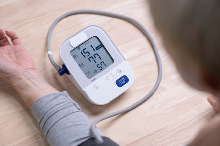Middle aged woman check blood pressure monitor and heart rate monitor with digital pressure gauge. Health care and Medical conceptの写真素材