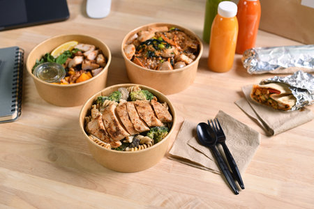 Having a lunch break at the office with delicious Healthy food delivery in take away boxes, Healthy eating concept.の写真素材