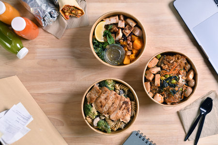 Having a lunch break at the office with delicious Healthy food delivery in take away boxes, Healthy...