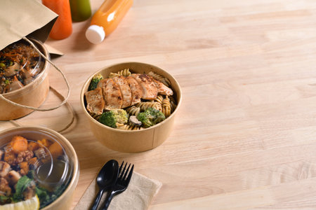 Having a lunch break at the office with delicious Healthy food delivery in take away boxes, Healthy eating concept.の写真素材