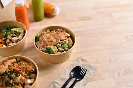 Having a lunch break at the office with delicious Healthy food delivery in take away boxes, Healthy eating concept.の写真素材
