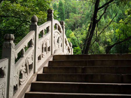 Chinese stone bridge with steps in the forestの写真素材