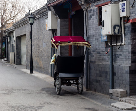 Beijing, China - March 8, 2015: Rickshaw cart parked on the quiet hutong streetのeditorial素材
