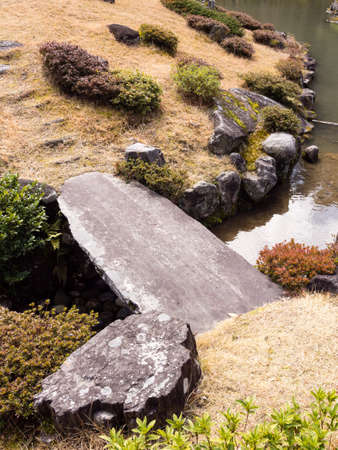 Stone bridge in a Japanese landscape gardenの写真素材