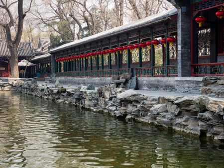 Long covered walkway in classical Chinese garden with pondのeditorial素材
