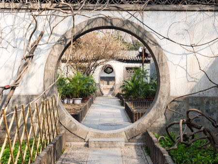Round gate in classical Chinese garden in Prince Gong Palace, Beijingのeditorial素材