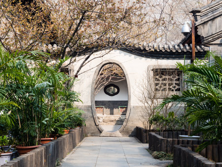 Oval shaped gate in classical Chinese garden in Prince Gong Palace, Beijingのeditorial素材