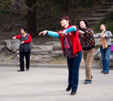 Beijing, China - March 8, 2015: Chinese ladies dancing in Beihai park on International Women's Dayのeditorial素材
