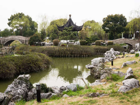 Traditional Chinese garden with pond in springtimeの写真素材