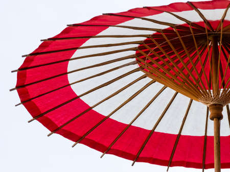 Red and white paper Japanese traditional wooden umbrellaの写真素材