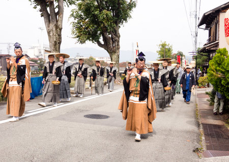 Takayama, Japan - October 10, 2015: Local people in traditional costumes marching the streets of historic Takayama during the annual Takayama Autumn Festival paradeのeditorial素材