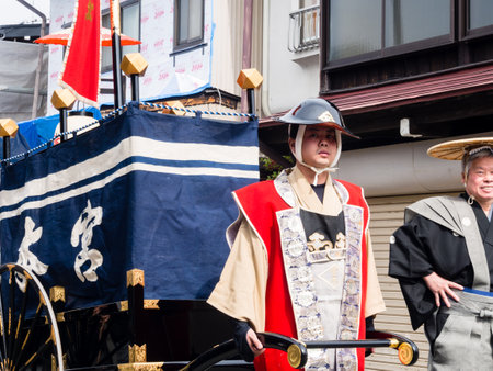 Takayama, Japan - October 10, 2015: Local man in traditional costume pulling festival cart along the narrow streets of Takayama old town during the annual Takayama Autumn Festival paradeのeditorial素材