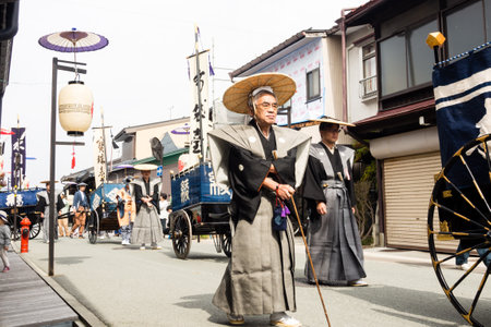 Takayama, Japan - October 10, 2015: Local people in traditional costumes marching the streets of historic Takayama during the annual Takayama Autumn Festival paradeのeditorial素材